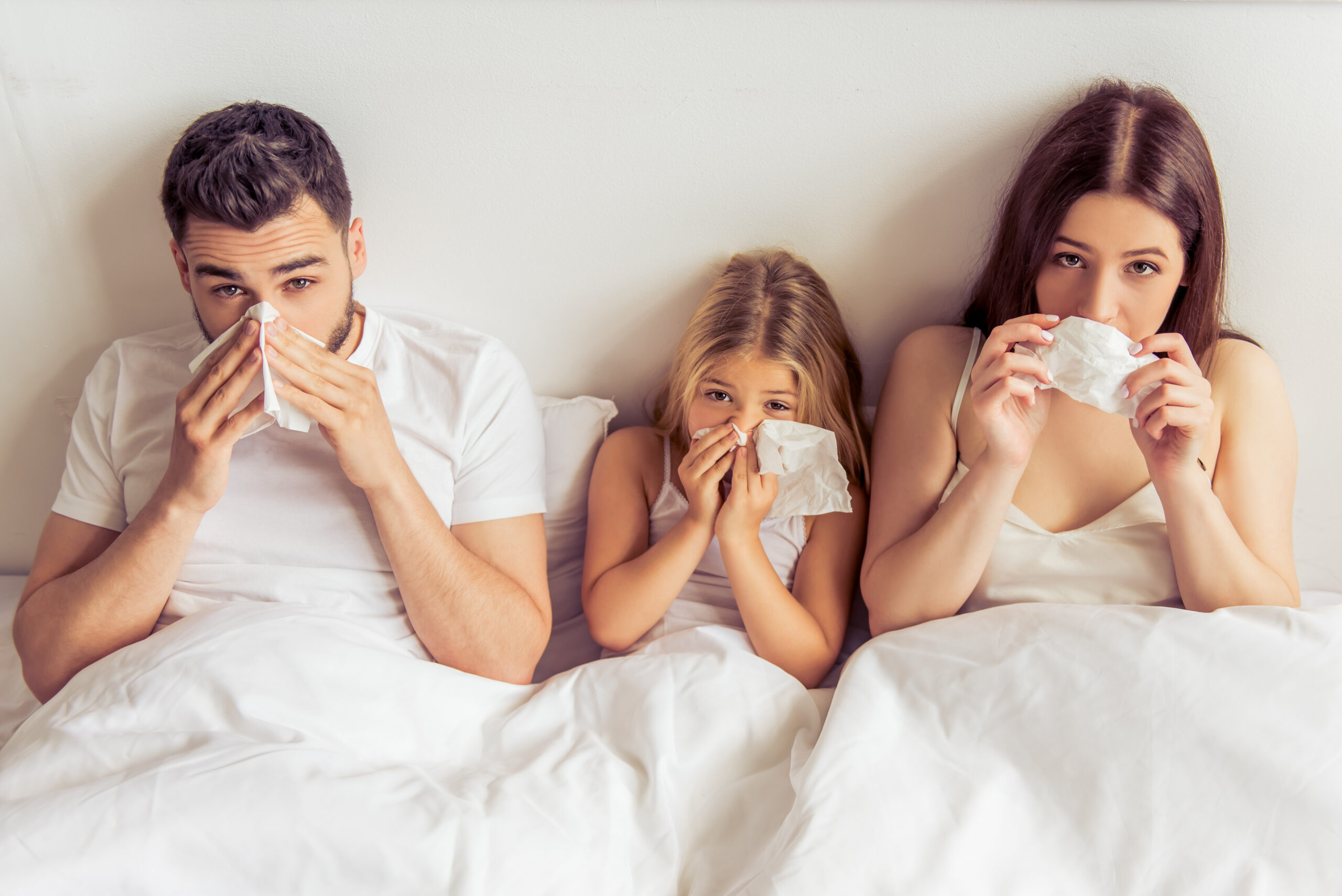 Family with tissues, seasonal allergy symptoms